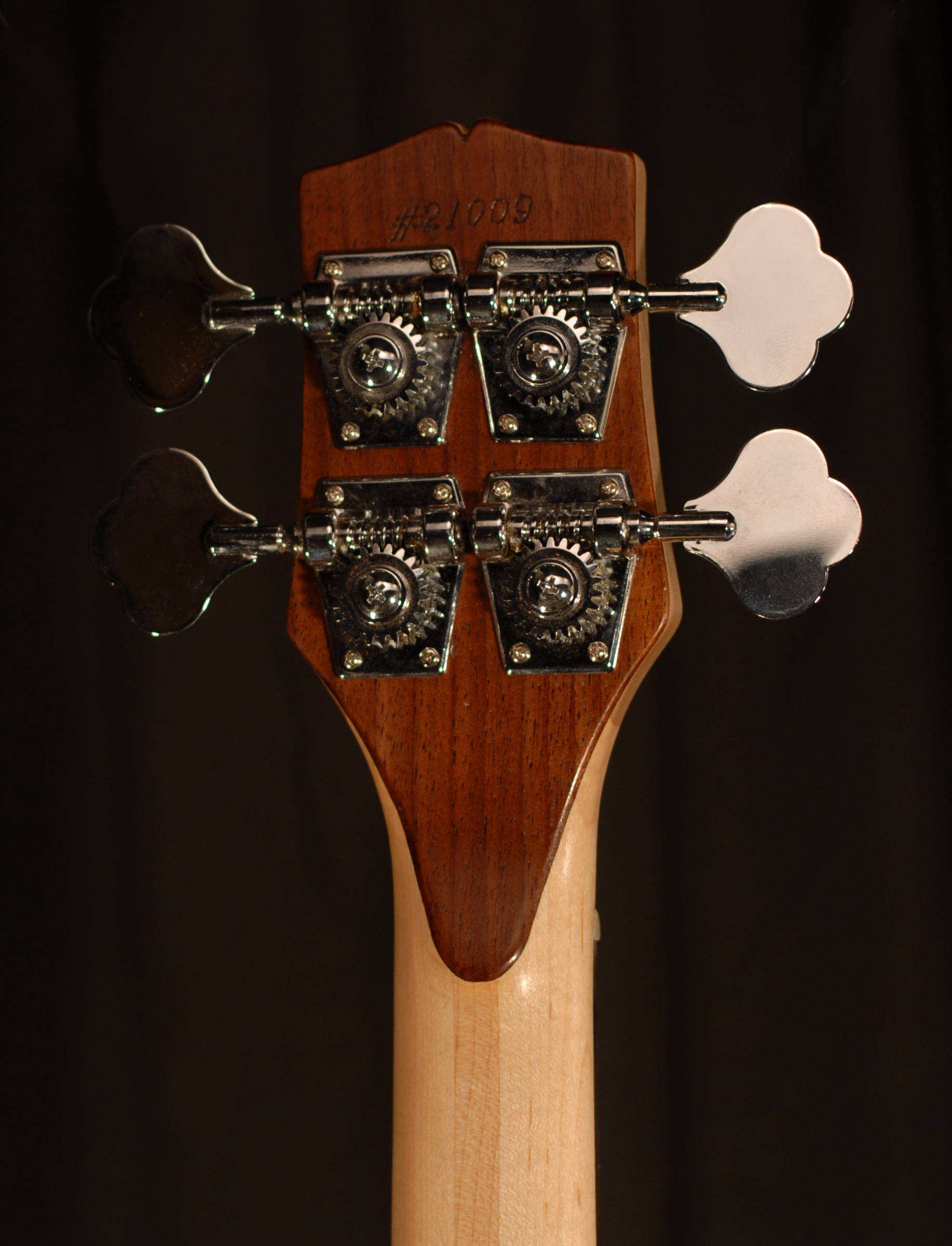 rear view of the headstock of michael mccarten's double cutaway electric bass guitar model