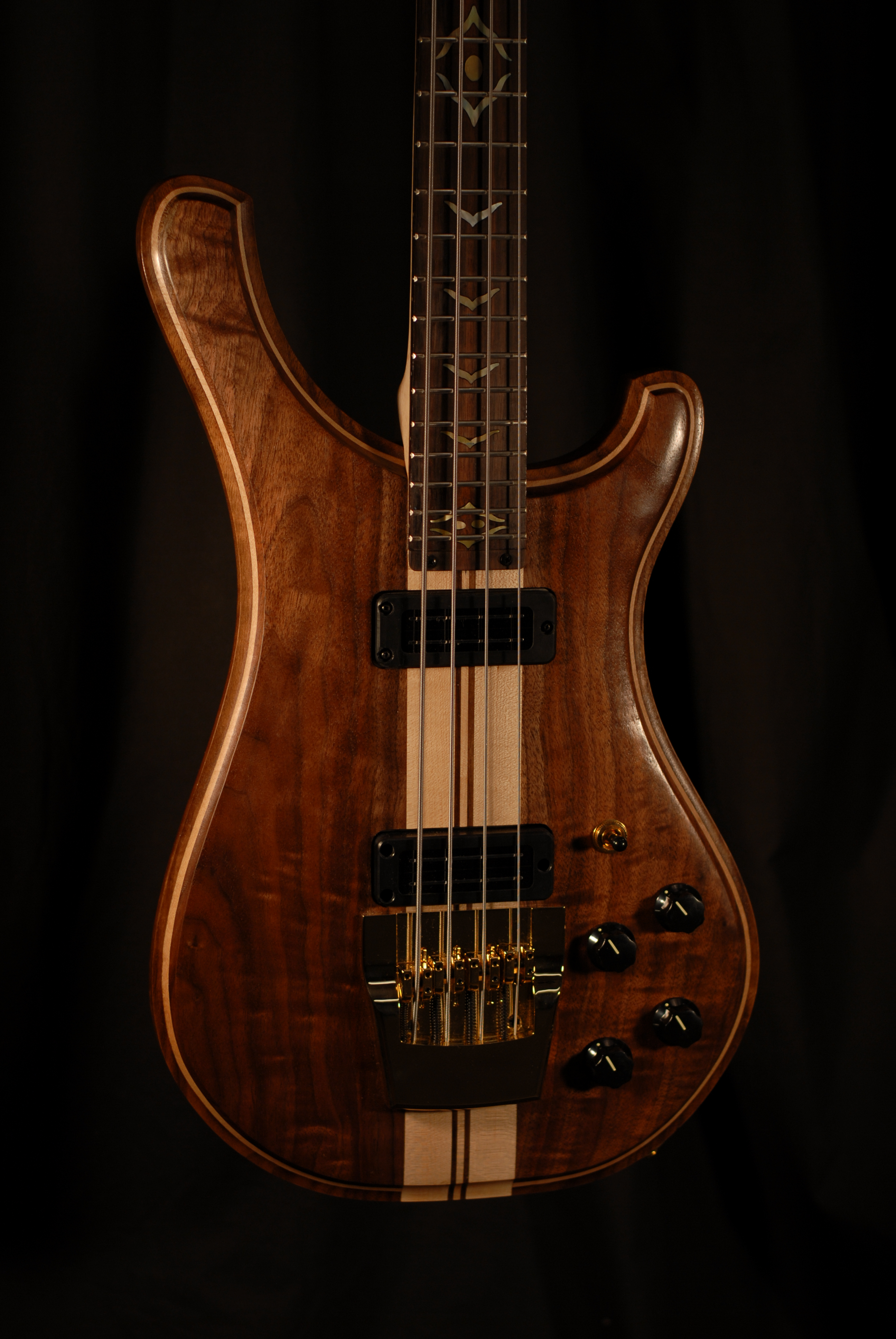 detailed front view of michael mccarten's double cutaway electric bass guitar model